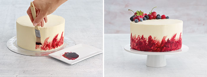 Two images: the left image is a white cake being painted with red flavor paste in upward brushstrokes. The right image is a finished cake with red brushstrokes at the bottom of the cake and fresh berry decorations. 
